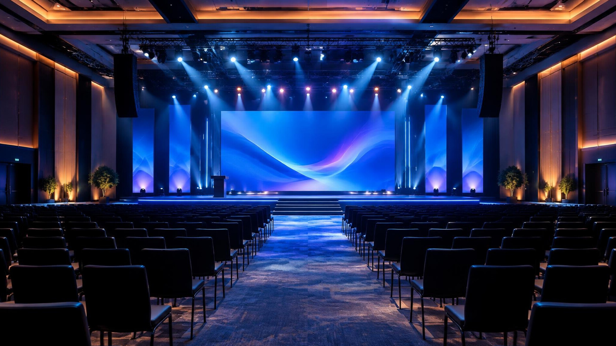 Large audience seated in front of a stage